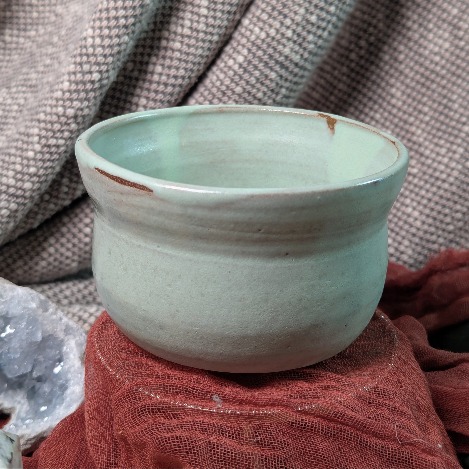 Mint Green Matcha tea bowl with a textured surface on a fabric background