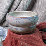 Ceramic bowl with a textured surface on a fabric background