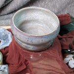 Ceramic bowl with textured surface on a fabric background