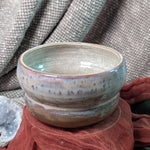 Ceramic bowl with a textured surface on a fabric background