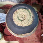 Ceramic bowl with potter's stamp on the bottom