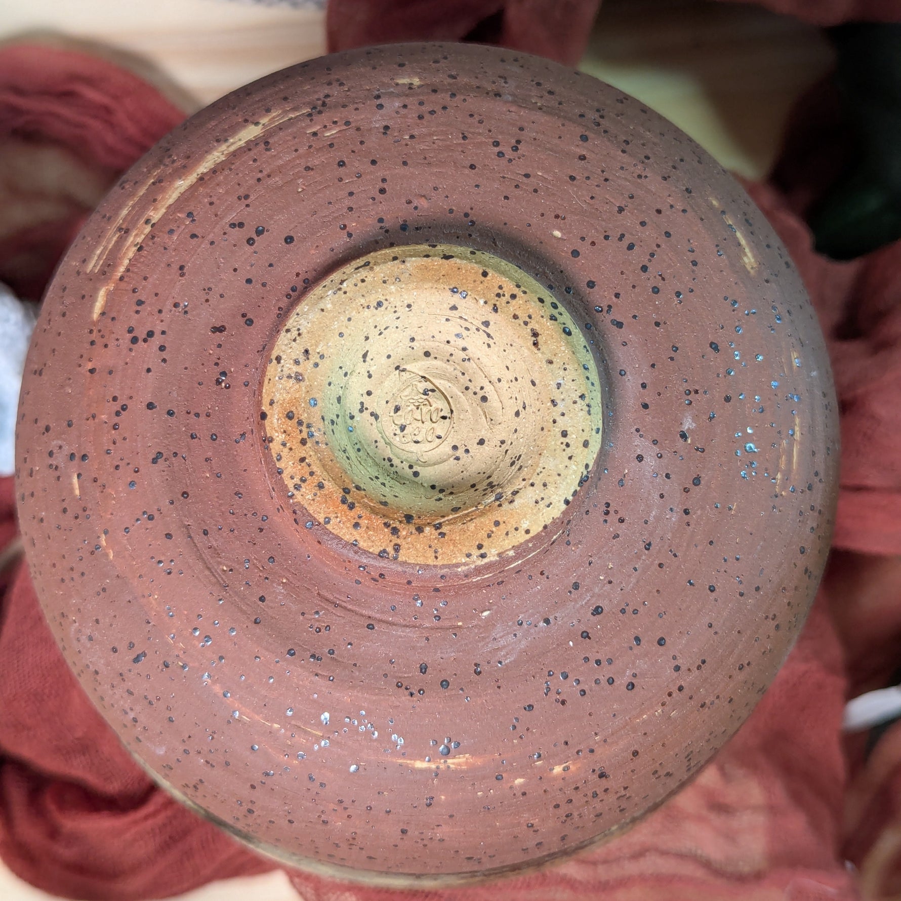 Close-up of a ceramic pot with potter's stamp on the bottom